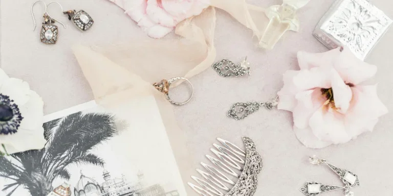 Silver Jewelry on the Table Among Flowers