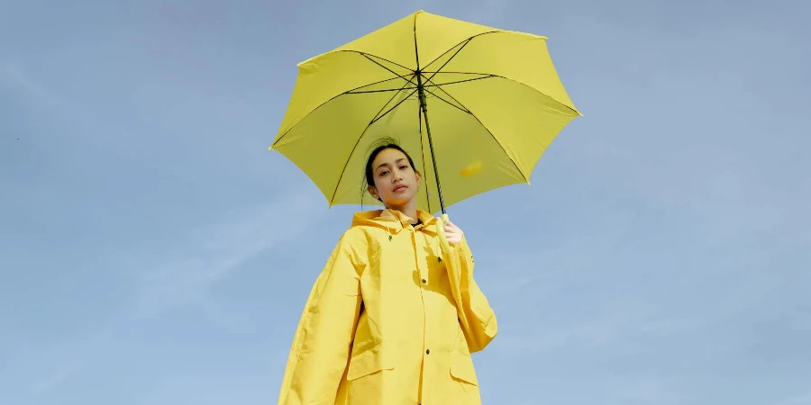 young Asian female with dark hair in bright raincoat