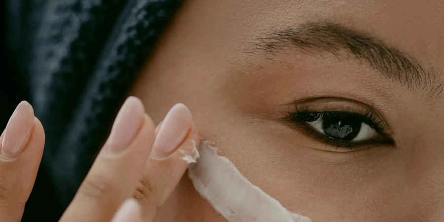 Woman applying Facial Cream on Face