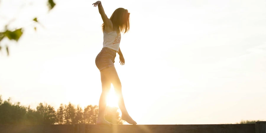 Woman Walking On Fence