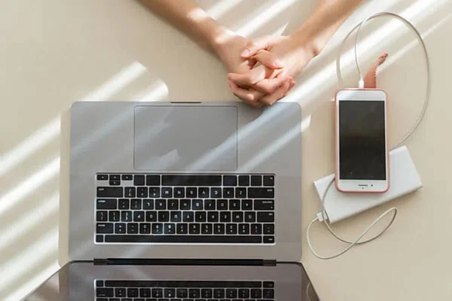 Minimalist office hands laptop phone charger