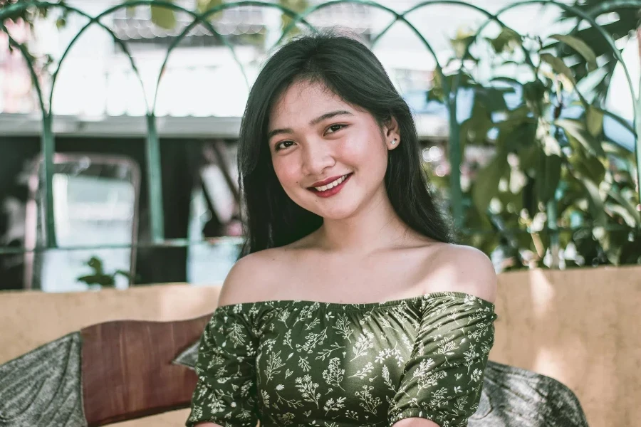 A Smiling Woman Wearing an Off-Shoulder Top