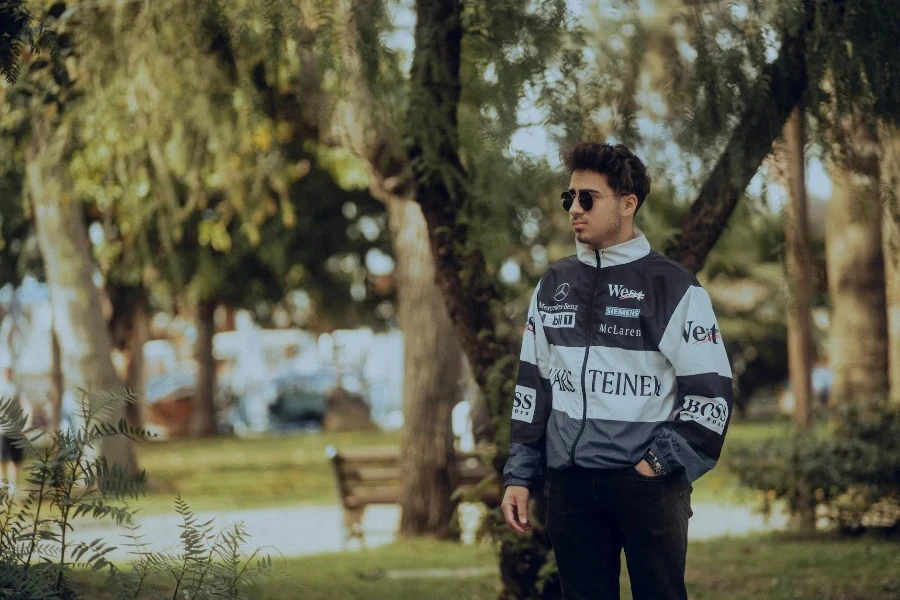 Man in Sunglasses and Racing Jacket at Park