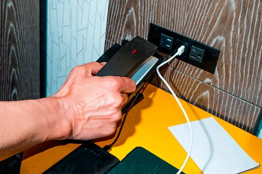 man grabs the handset of a telephone