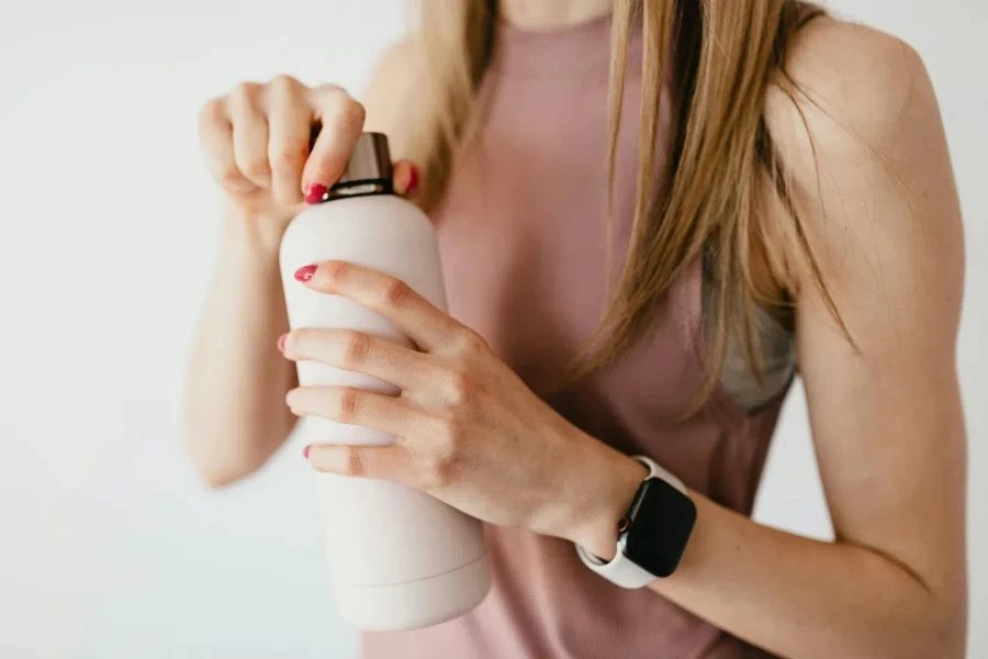 young female in casual outfit wearing smart watch