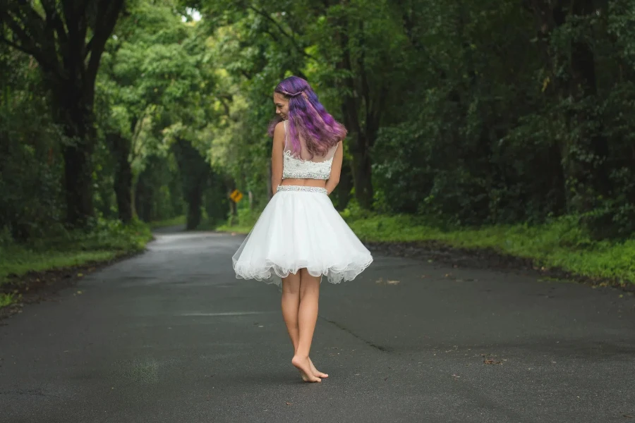 Smiling Woman with Purple Hair Posing in White Skirt