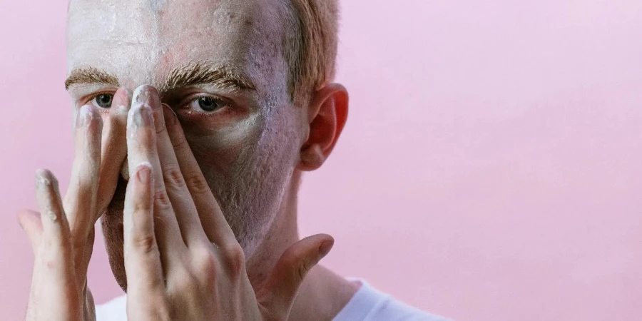 Man in White Crew Neck Shirt Covering His Face With His Hand