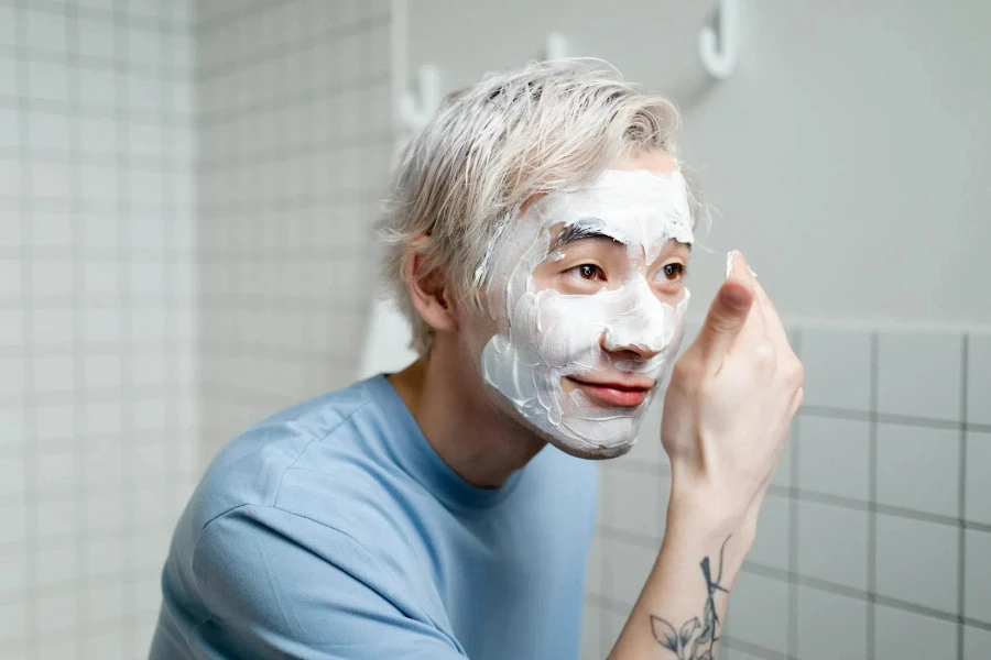 Man in Blue Crew Neck Shirt With White Cream On Face