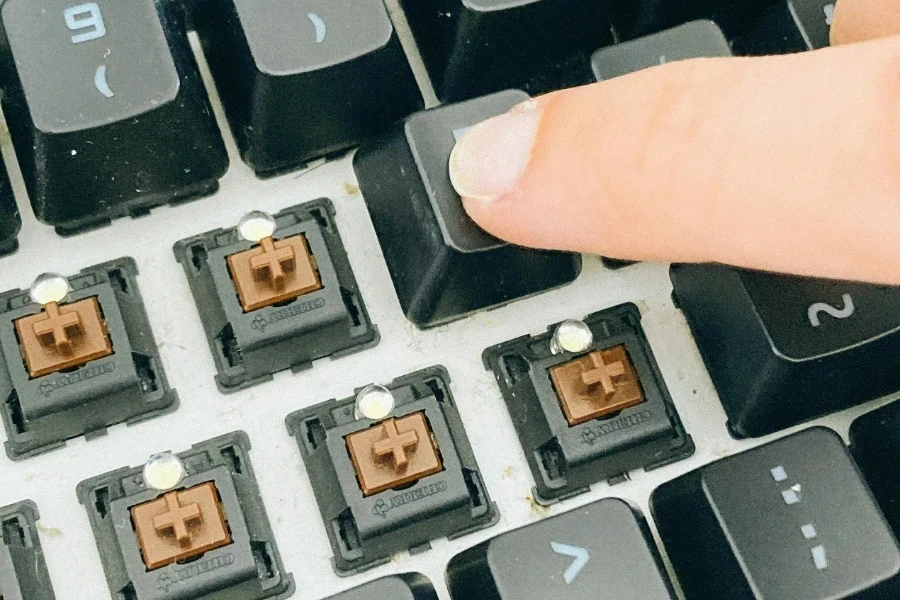 Person pushing keycaps after cleaning keypad