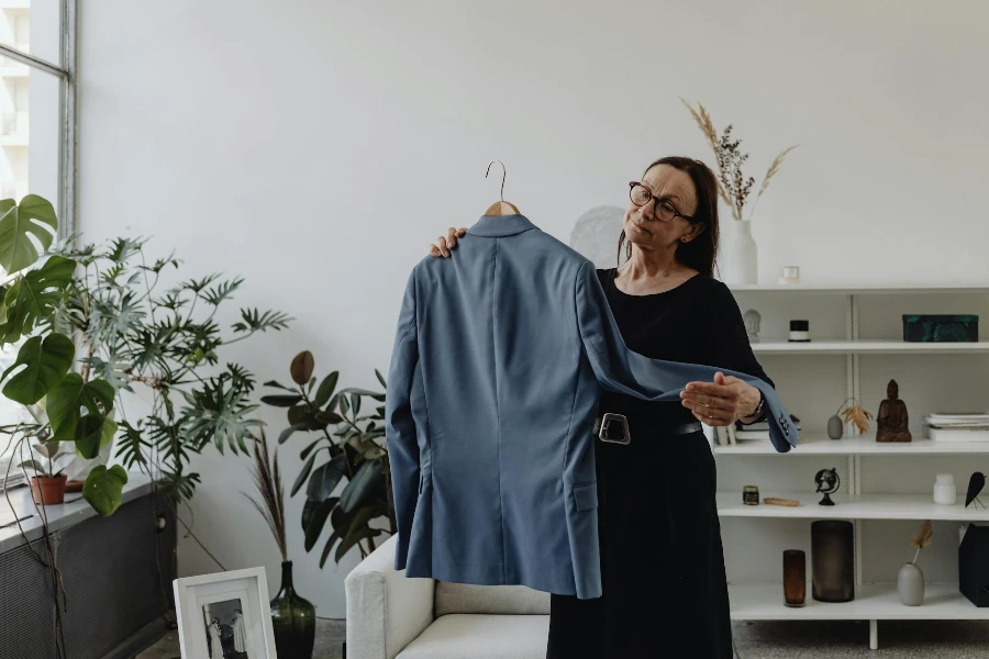 Woman Looking at Jacket with Sadness