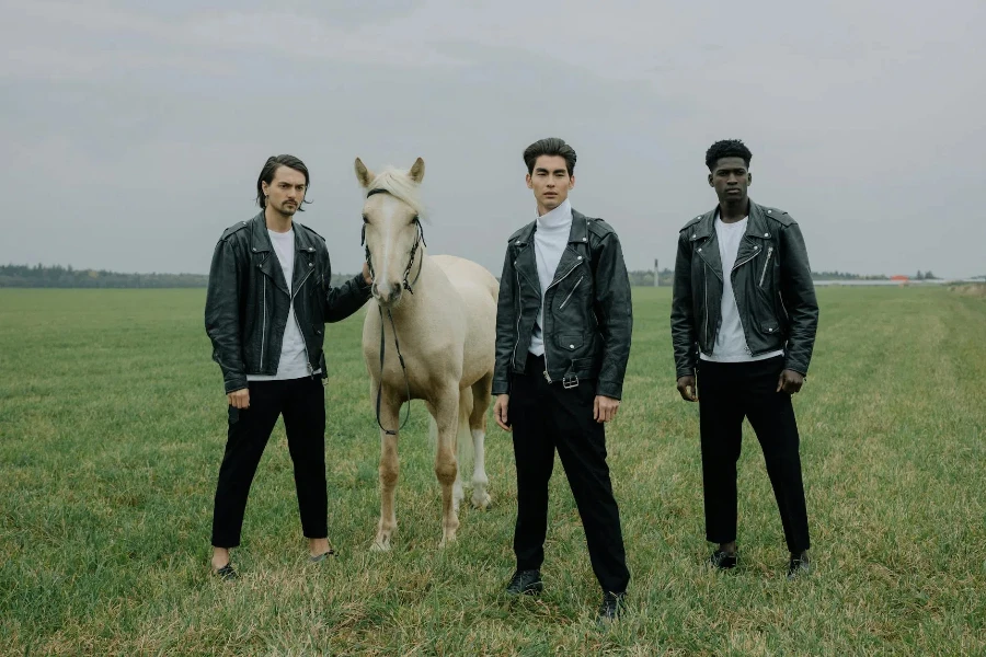 Men Standing Beside White Horse on Grassland