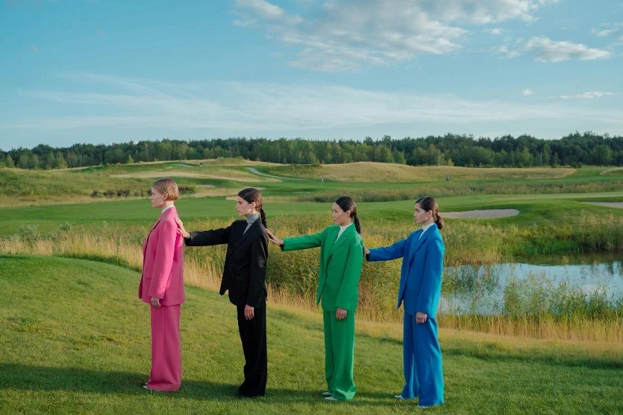 Group of Women Wearing Blazers and Trousers in Different Colors