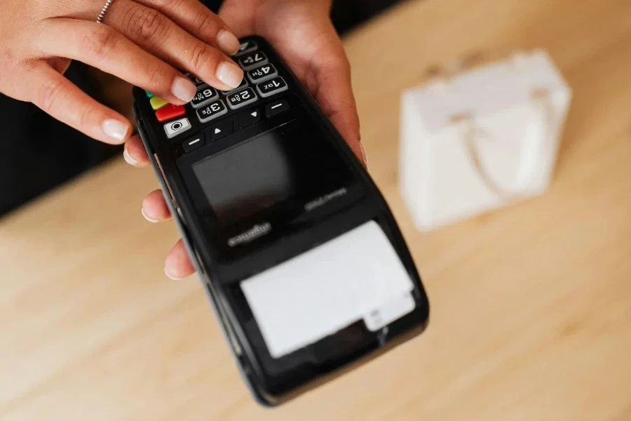 Person Holding A Black Device with Keypad