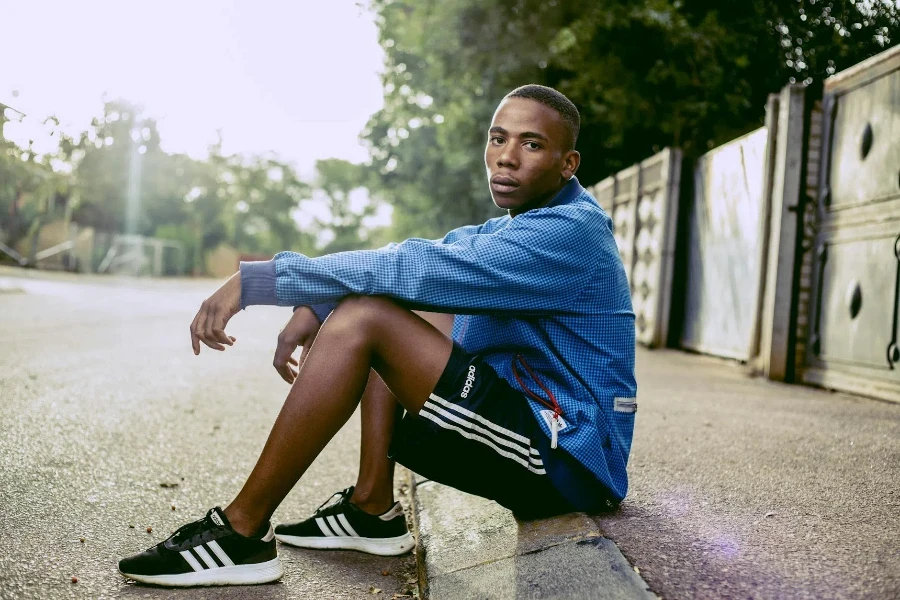 Photo Of Man Sitting On Concrete Floor