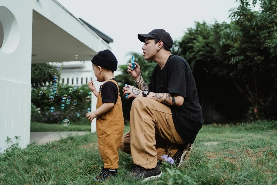 Father and Son Making Soap Bubbles in Patio