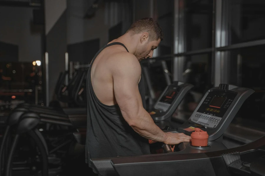 Man in Black Tank Top Using a Treadmill