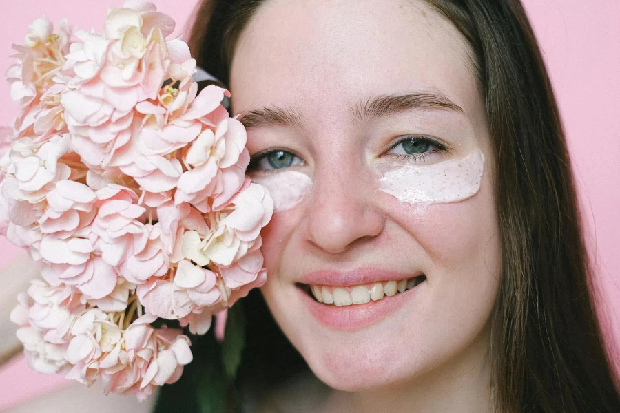 young female model with eye cream