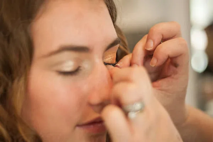 applying false eyelashes