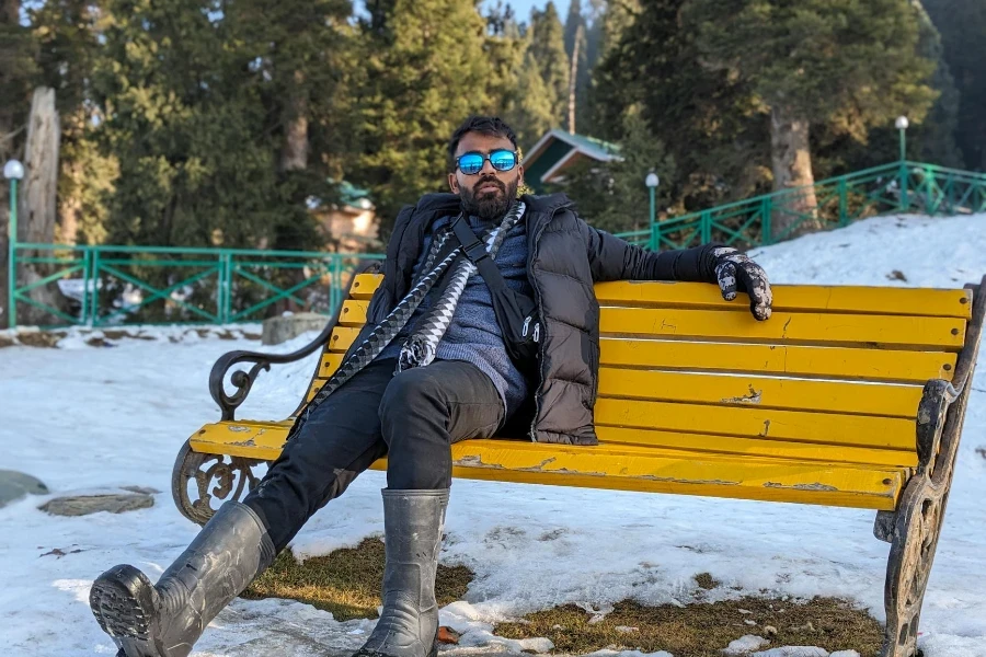 A man sitting on a bench in the snow