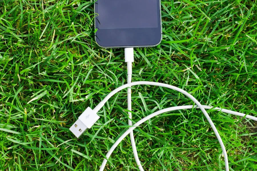 Black Ipod Touch and Cable on Grass