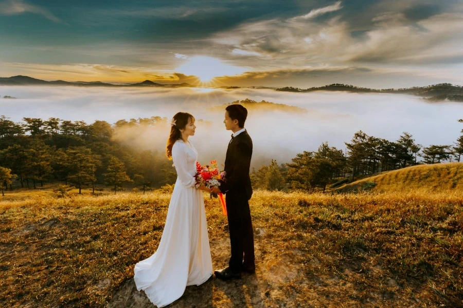 Couple Standing On Grass Field