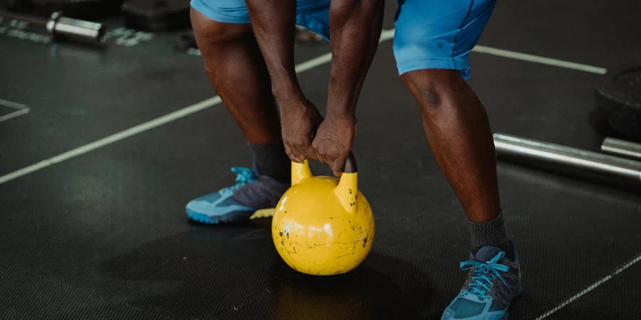 Person Using Yellow Kettlebell