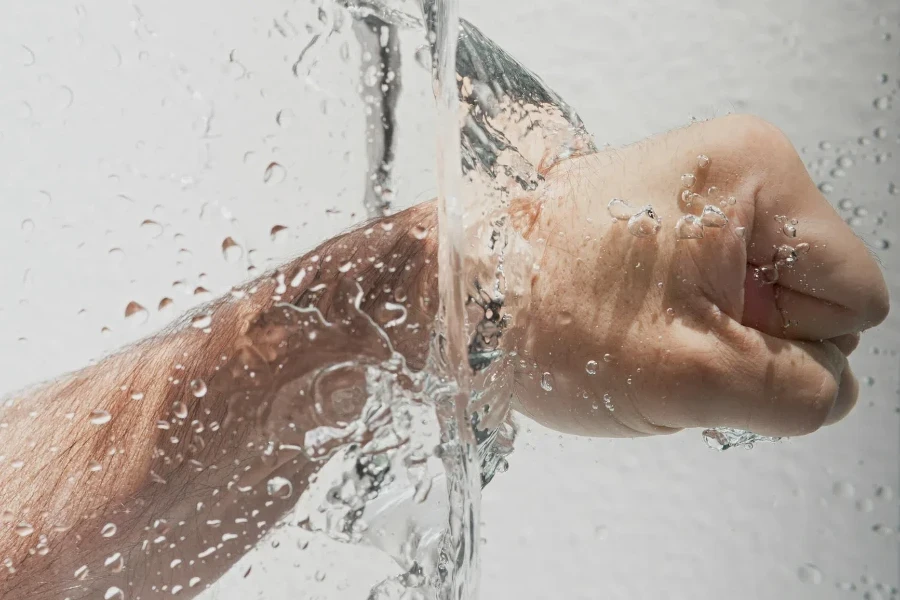 Person's Left Fist Punching Water