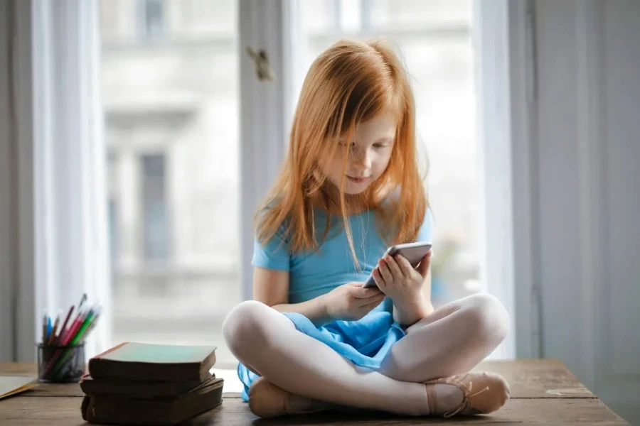 Red haired charming schoolgirl in blue dress