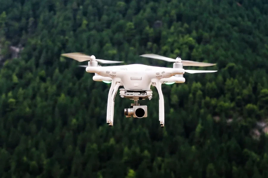 a drone with a camera is flying in the forest