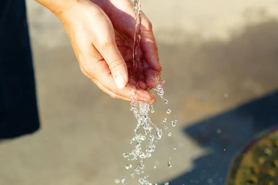 Water Pouring on Person's Hand