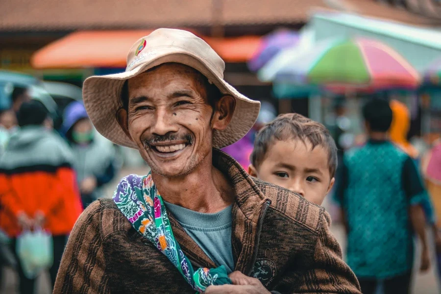 Cheerful ethnic man in panama hat