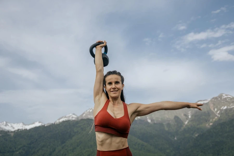 Photo of a Woman Lifting a Kettlebell