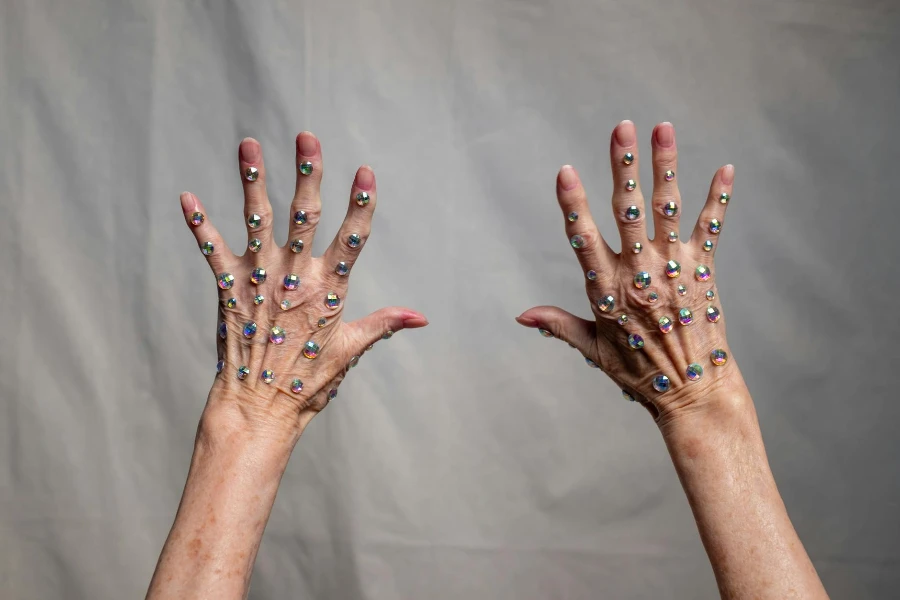 Person With Blue Manicure on White Textile