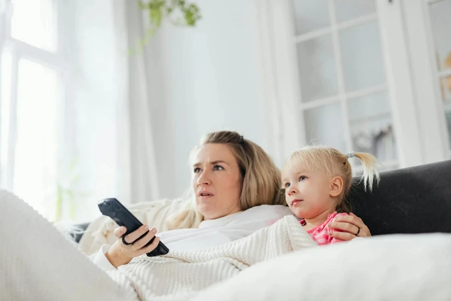 Blonde Woman Holding a Remote Control