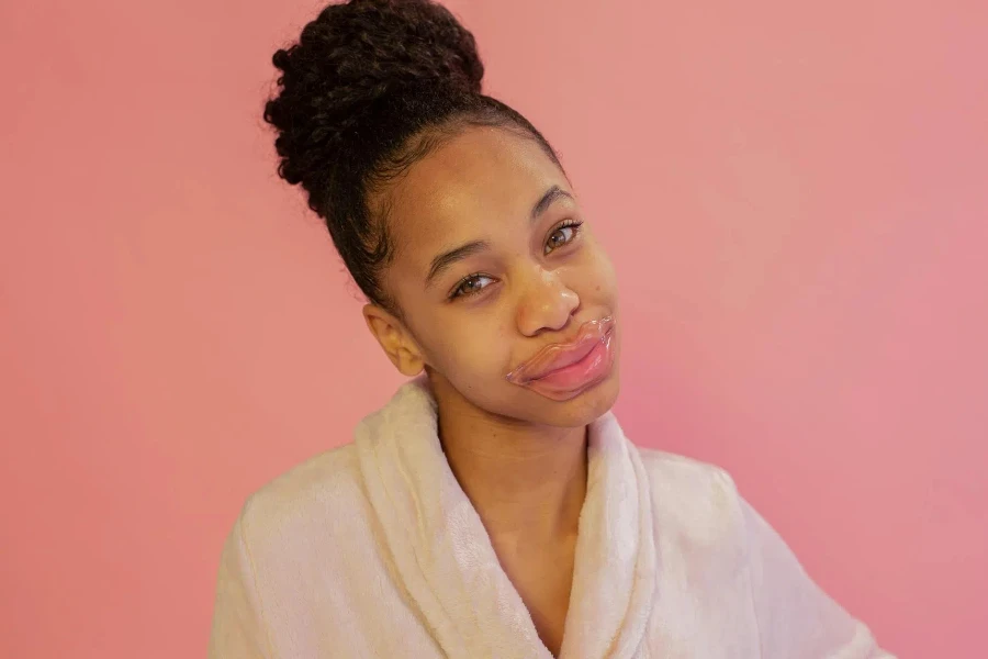 Smiling black woman wearing lip mask