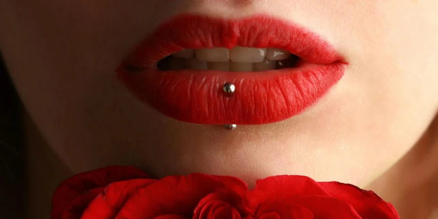 Woman Wearing Red Lipstick Near Red Rose