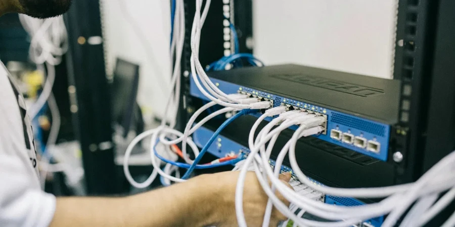 Electronics Engineer Fixing Cables on Server