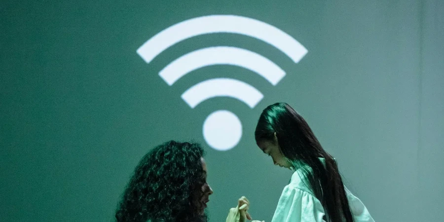 Woman in White Scrubs Connecting a Smartwatch of a Girl to Wifi