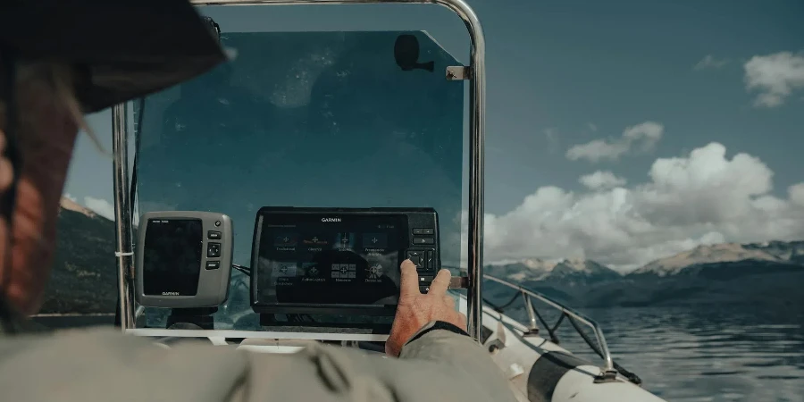 Man Touching an Electronic Device in a Boat