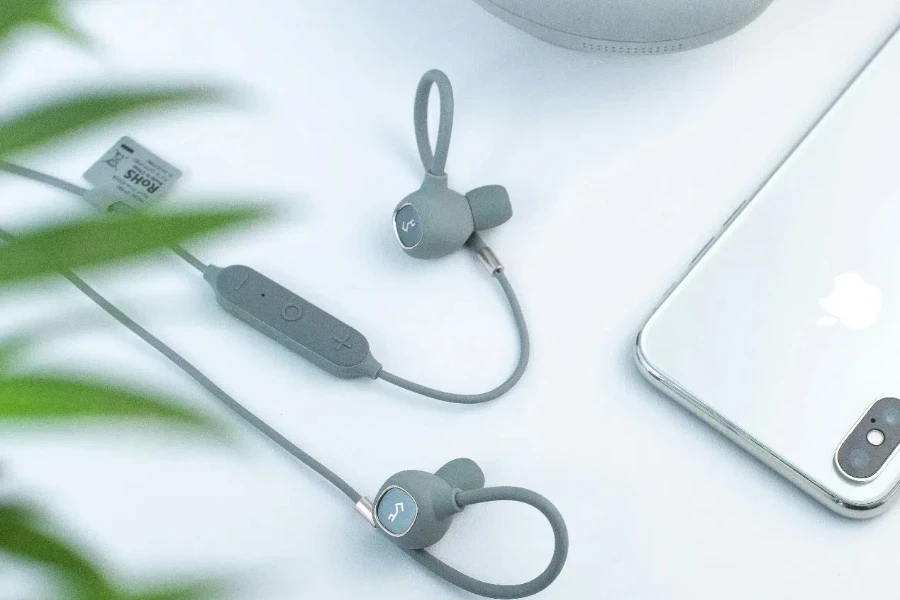 green plant leaves arrangement of modern wired earphones