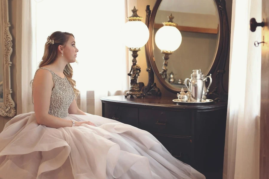 Woman Wearing Gown Looking at Mirror