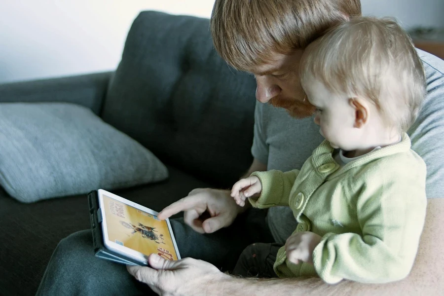 Father and Child Sitting on Gray Couch