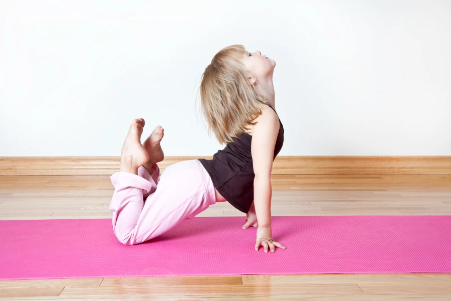 little girl stretching, practising yoga posesMore like this