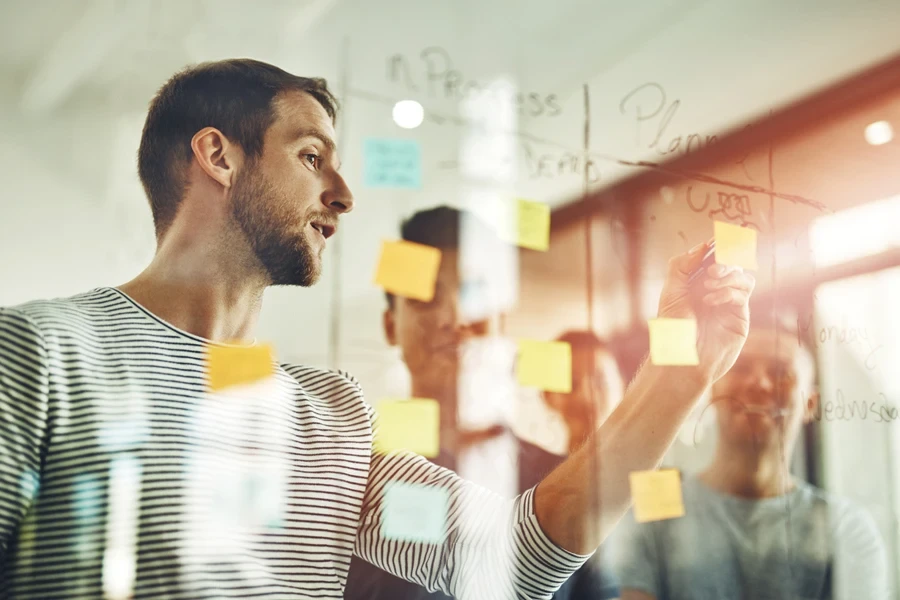 men using sticky notes in a brainstorm session