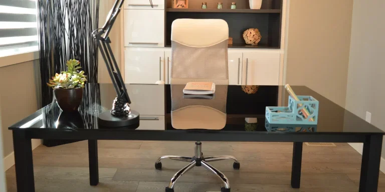 Office desk with lamp, flowers and organizer