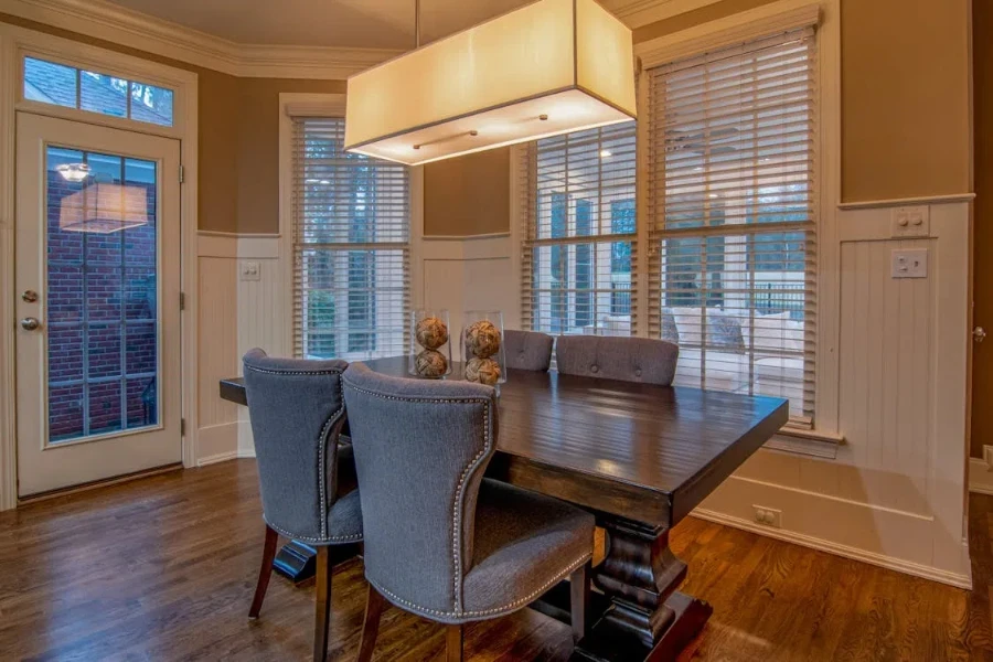 Ornate wooden dining table with four elegantly upholstered chairs