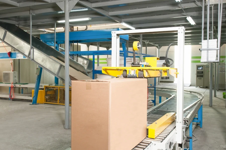 packed electrical engineering cardboard boxes on a conveyor belt in factory