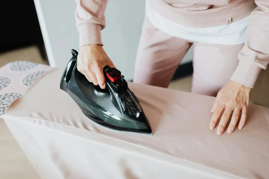 Person ironing on a standing ironing board