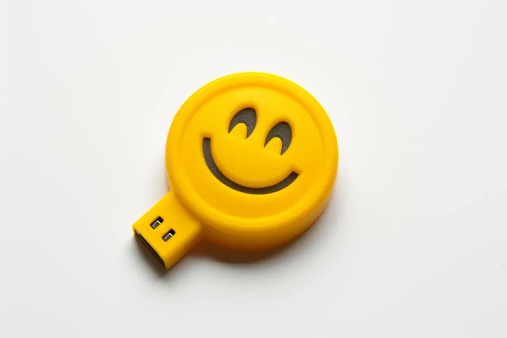 plastic smiley face shaped yellow pen drive