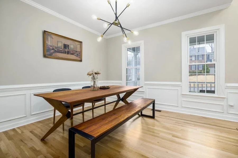 Rectangular wooden table with wood and metal bench and chairs